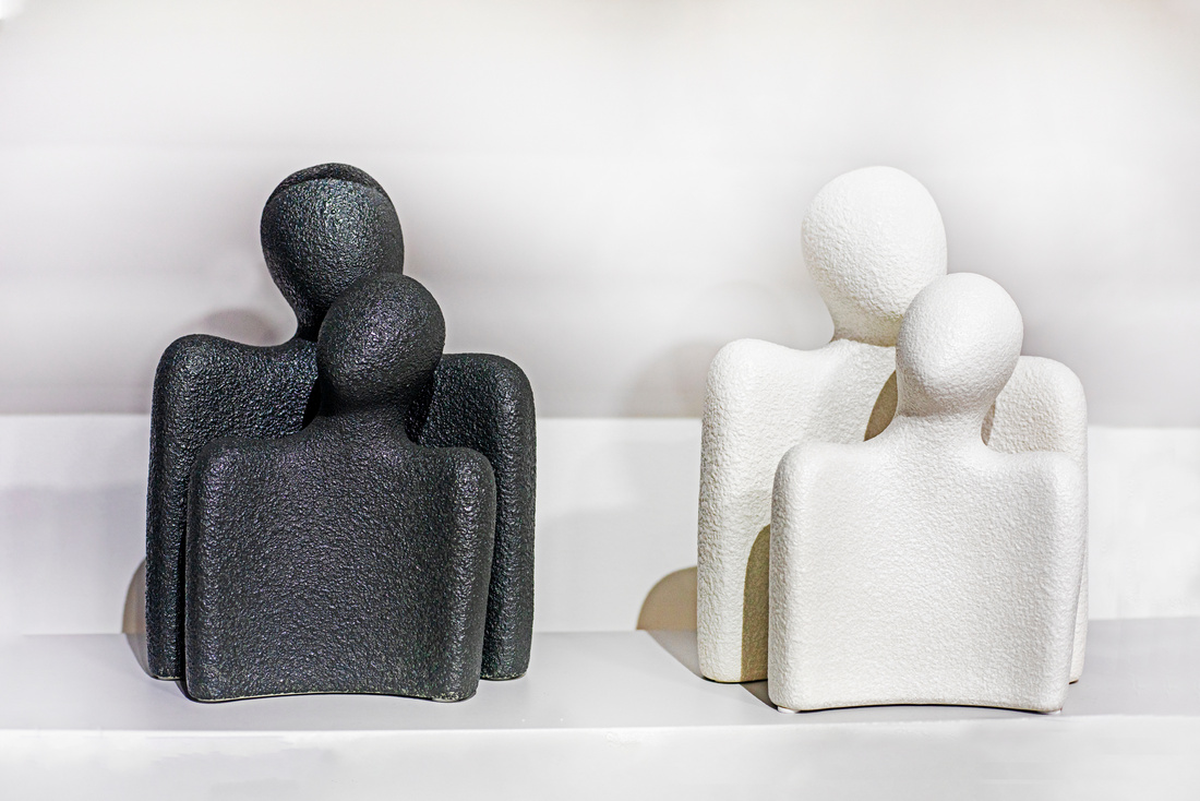 conceptual desktop contrasting black and white figurines of a wo